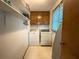 Functional laundry room with ample shelving and essential appliances for convenience at 772 Garner Sw Rd, Lilburn, GA 30047
