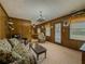 Relaxing living room with carpet flooring, wood paneling, and plenty of natural light at 772 Garner Sw Rd, Lilburn, GA 30047