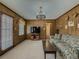 Spacious living room featuring wood paneling, carpet, and access to the outdoors at 772 Garner Sw Rd, Lilburn, GA 30047