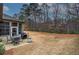 Back patio features outdoor furniture, potted plants and grill with serene wooded views at 104 Big Meadows Dr, Canton, GA 30114