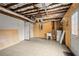 Spacious basement featuring tile flooring, utility sink, water heater and door to outside at 1364 Tsali Trl, Morrow, GA 30260