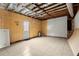 Spacious basement featuring tile flooring, door to outside, and open ceiling at 1364 Tsali Trl, Morrow, GA 30260