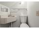 Compact half bathroom featuring a corner sink and toilet at 1364 Tsali Trl, Morrow, GA 30260