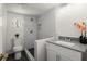 Renovated bathroom features tiled walk-in shower, white vanity, and contemporary fixtures at 1364 Tsali Trl, Morrow, GA 30260