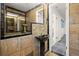 Unique bathroom featuring stone walls, modern fixtures and a black pedestal sink at 1364 Tsali Trl, Morrow, GA 30260