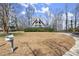 A-frame house exterior featuring unique architectural design, a deck, and a mailbox near the driveway at 1364 Tsali Trl, Morrow, GA 30260