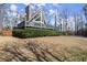 A-frame house featuring a chimney, a large deck, and attractive landscaping in a residential setting at 1364 Tsali Trl, Morrow, GA 30260