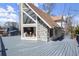 View from the deck showcasing A-frame design with stone siding and large glass windows at 1364 Tsali Trl, Morrow, GA 30260