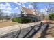 View of A-frame home with wraparound deck, set in a landscaped yard at 1364 Tsali Trl, Morrow, GA 30260