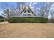 Exterior shot of A-frame house with deck, stone chimney, and landscaping at 1364 Tsali Trl, Morrow, GA 30260