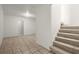 Bright hallway with tiled floor and carpeted stairs leading to the upper level at 1364 Tsali Trl, Morrow, GA 30260