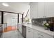 Open kitchen offers white cabinets, stainless appliances, tile backsplash, and views to the main living area at 1364 Tsali Trl, Morrow, GA 30260