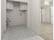 Functional laundry room with tiled floors and storage cabinets at 1364 Tsali Trl, Morrow, GA 30260