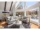 Cozy living room with high ceilings and views of the outdoor deck and treed yard at 1364 Tsali Trl, Morrow, GA 30260