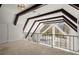 The loft has carpet floors, a metal railing, and a window with dark trim at 1364 Tsali Trl, Morrow, GA 30260