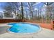 Inviting backyard pool is surrounded by a wooden deck and mature landscaping at 1364 Tsali Trl, Morrow, GA 30260
