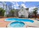 Enjoy a dip in this backyard pool and hot tub, surrounded by mature trees at 1364 Tsali Trl, Morrow, GA 30260