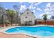 Backyard pool surrounded by mature landscaping provides a relaxing outdoor oasis at 1364 Tsali Trl, Morrow, GA 30260