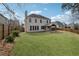 Rear exterior view of home with large lawn, patio, and a fenced-in yard at 2815 Chandler Grove Dr, Buford, GA 30519