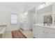 Bright bathroom featuring dual sink vanity, neutral tile flooring, soaking tub and a separate shower at 2815 Chandler Grove Dr, Buford, GA 30519