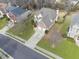 Aerial view of a well-maintained, two-story house with green lawn, driveway, and landscaped surroundings at 2815 Chandler Grove Dr, Buford, GA 30519