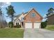 Beautiful two-story brick home with a well-kept lawn and a two-car garage at 2815 Chandler Grove Dr, Buford, GA 30519