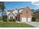 Charming two-story brick home with a well-manicured lawn and attached two-car garage at 2815 Chandler Grove Dr, Buford, GA 30519