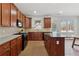 A modern kitchen features custom cabinetry, stainless steel appliances, and an island, perfect for cooking and entertaining at 2815 Chandler Grove Dr, Buford, GA 30519