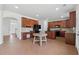 Spacious kitchen featuring custom wood cabinetry, black appliances, and a central island with a unique brick-style floor at 2815 Chandler Grove Dr, Buford, GA 30519