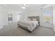Spacious main bedroom with tray ceiling, neutral carpet, and abundant natural light from large windows at 2815 Chandler Grove Dr, Buford, GA 30519
