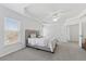 Bright main bedroom featuring a neutral palette, tray ceiling, plush carpet, and a large window at 2815 Chandler Grove Dr, Buford, GA 30519