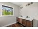Bathroom featuring a double vanity, hardwood floors, modern lighting, and a large window with a scenic view at 2873 Sylvan Rd, East Point, GA 30344