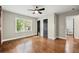 Bedroom with hardwood floors, a ceiling fan, and two closets with an open door to the bathroom at 2873 Sylvan Rd, East Point, GA 30344