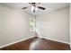 Cozy bedroom featuring hardwood floors, a ceiling fan with lighting, and a bright window at 2873 Sylvan Rd, East Point, GA 30344