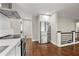 Open kitchen featuring stainless steel appliances and a refrigerator next to a stairwell at 2873 Sylvan Rd, East Point, GA 30344