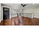 Open-concept living room with hardwood floors flowing into a kitchen area with white cabinets and island at 2873 Sylvan Rd, East Point, GA 30344