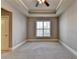 Neutral bedroom with large window, carpet flooring, and base molding at 6444 Chariot St, Atlanta, GA 30328