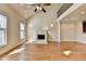 Open living room with hardwood floors, vaulted ceiling, fireplace, and open loft space, creating a bright atmosphere at 6444 Chariot St, Atlanta, GA 30328