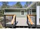 Back deck with railing and steps, attached to a screened in porch and the house's exterior at 6875 Sunny Brook Ln, Atlanta, GA 30328