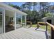 Stunning screened in porch overlooking the backyard with a deck, storage shed, and fire pit at 6875 Sunny Brook Ln, Atlanta, GA 30328