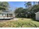 Lovely backyard with a deck, screened in porch, storage shed, green grass, and fire pit at 6875 Sunny Brook Ln, Atlanta, GA 30328