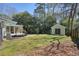 Spacious backyard with deck, screened-in porch, storage shed, green grass, and fire pit at 6875 Sunny Brook Ln, Atlanta, GA 30328