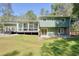 Expansive backyard featuring a patio, sunroom, and lush greenery, perfect for outdoor relaxation and entertaining at 6875 Sunny Brook Ln, Atlanta, GA 30328