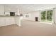 Spacious finished basement with a bar, windows, and sliding glass door at 6875 Sunny Brook Ln, Atlanta, GA 30328