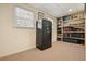 Finished basement area with a large Liberty safe and built in bookshelf for ample storage options at 6875 Sunny Brook Ln, Atlanta, GA 30328