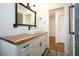 Bathroom with wood counter, vessel sink, modern fixtures, and hallway access at 6875 Sunny Brook Ln, Atlanta, GA 30328