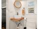 Modern half-bathroom with vessel sink, wood counter, window, and toilet at 6875 Sunny Brook Ln, Atlanta, GA 30328