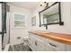 Bright bathroom boasts a live edge wood counter, vessel sink, and modern fixtures at 6875 Sunny Brook Ln, Atlanta, GA 30328