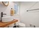 Bright half-bathroom featuring a wood counter, a vessel sink, and a window at 6875 Sunny Brook Ln, Atlanta, GA 30328