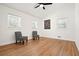Bright bedroom with hardwood floors, a ceiling fan, and three windows at 6875 Sunny Brook Ln, Atlanta, GA 30328